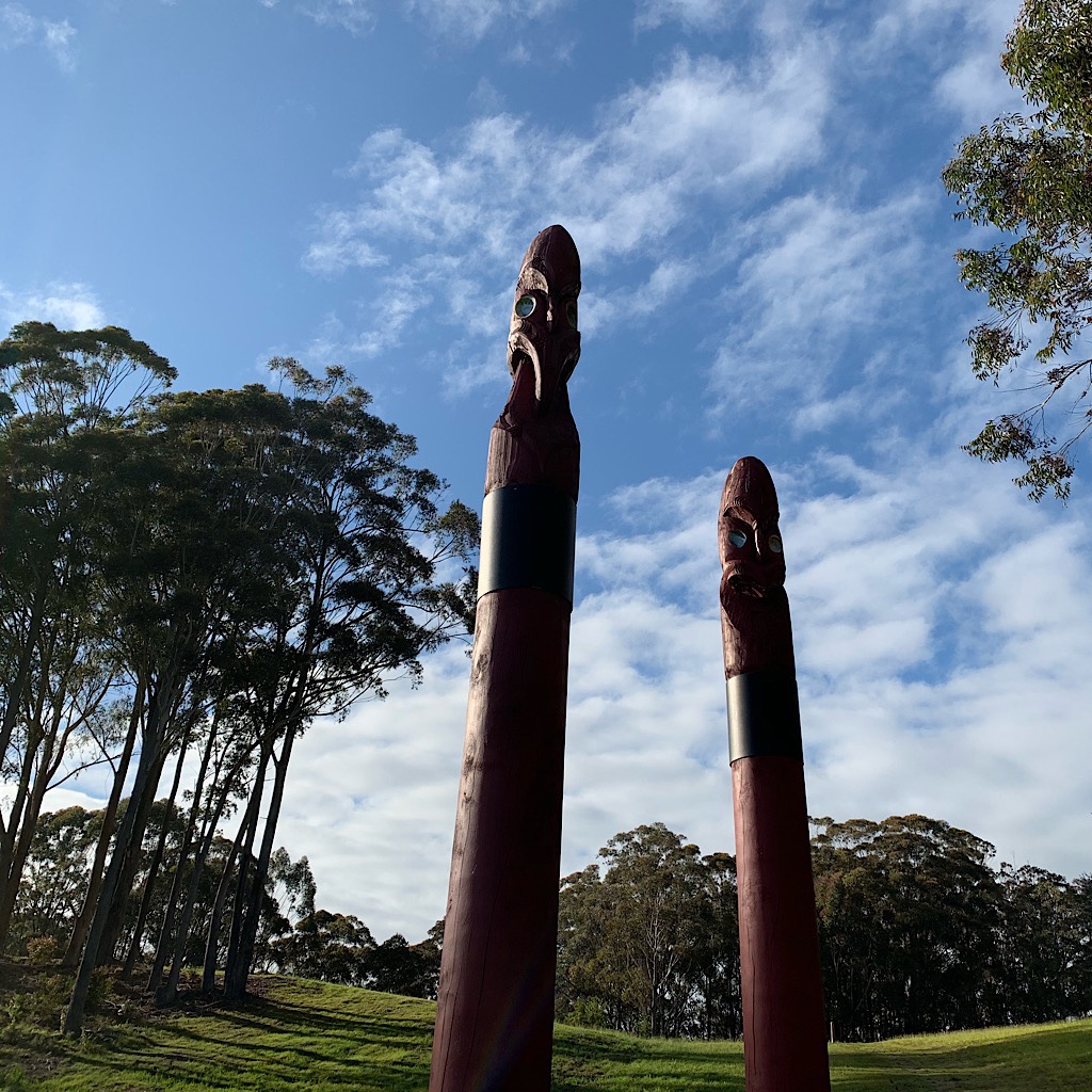A Māori pou whenua or "land post" that marks territory and tells a story, much like totem poles.