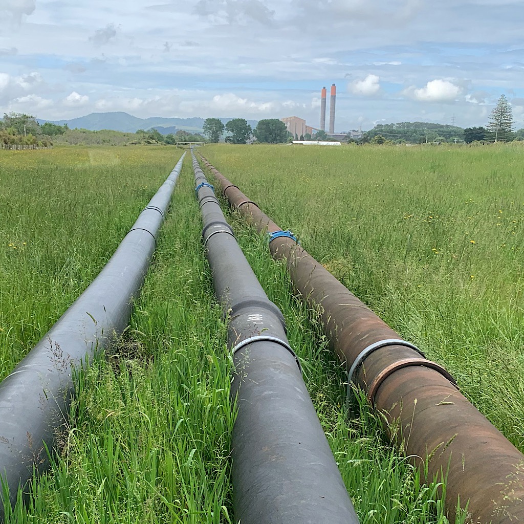 Pipes leading from the Huntly Power Station with the Hakarimata Range in the distance.