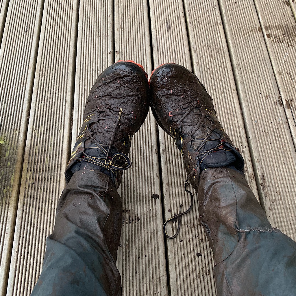 Mud-caked shoes, socks and trousers. Fortunately the hut has a "mud room."