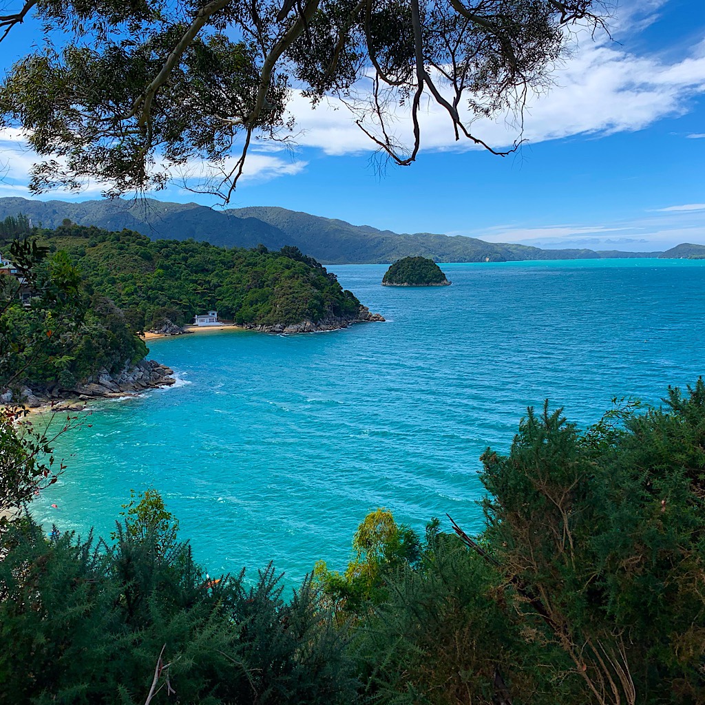 The mountains seems to grow out of the aquamarine water and golden sand of Abel Tasman park. 