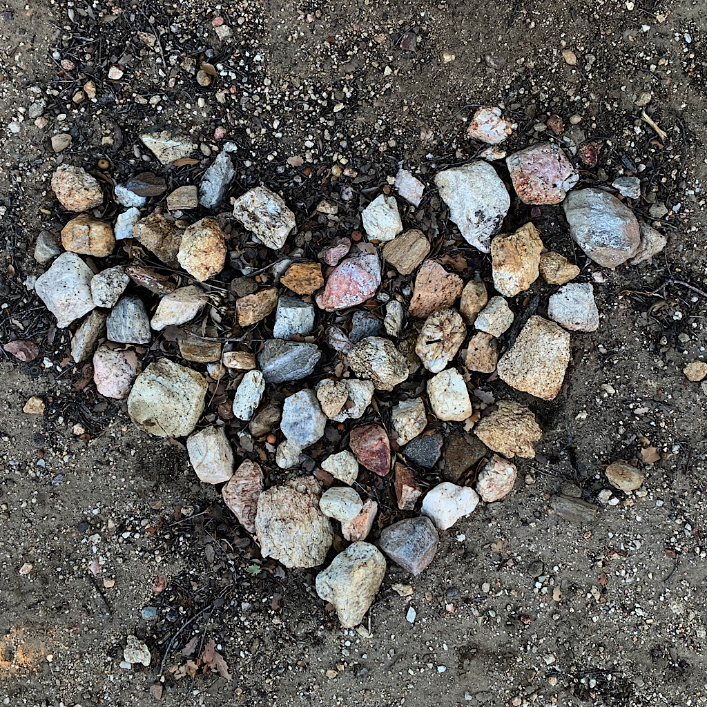 A hiker long gone leaves a heart made of collected stones. 