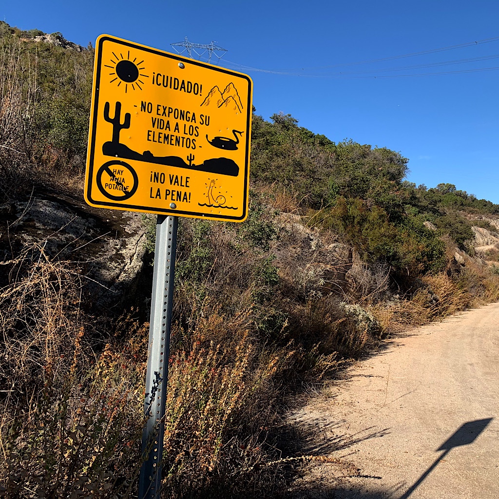 Signs warn border crossers of the dangers of the desert.