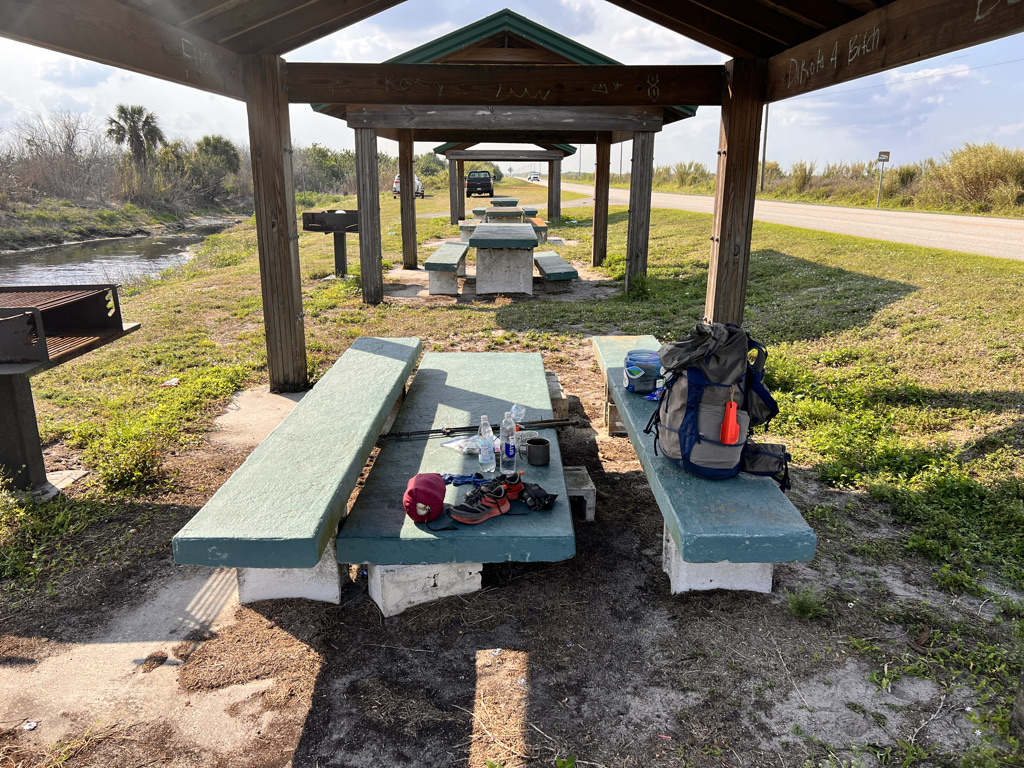 The weird little rest area at the highway with busted concrete picnic tables. I'll take shade wherever I can get it. 