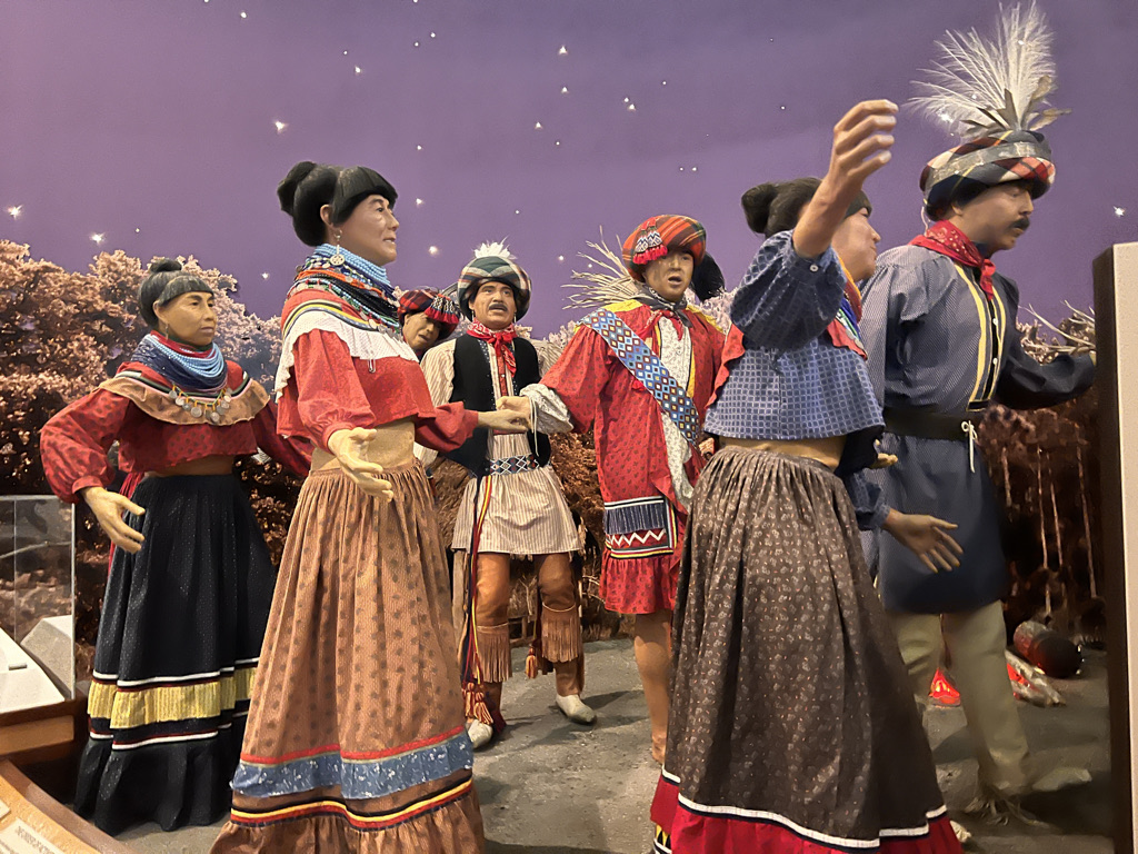 Dancing in traditional dress. These colorful patchwork outfits are not costumes, rather everyday outfits. 